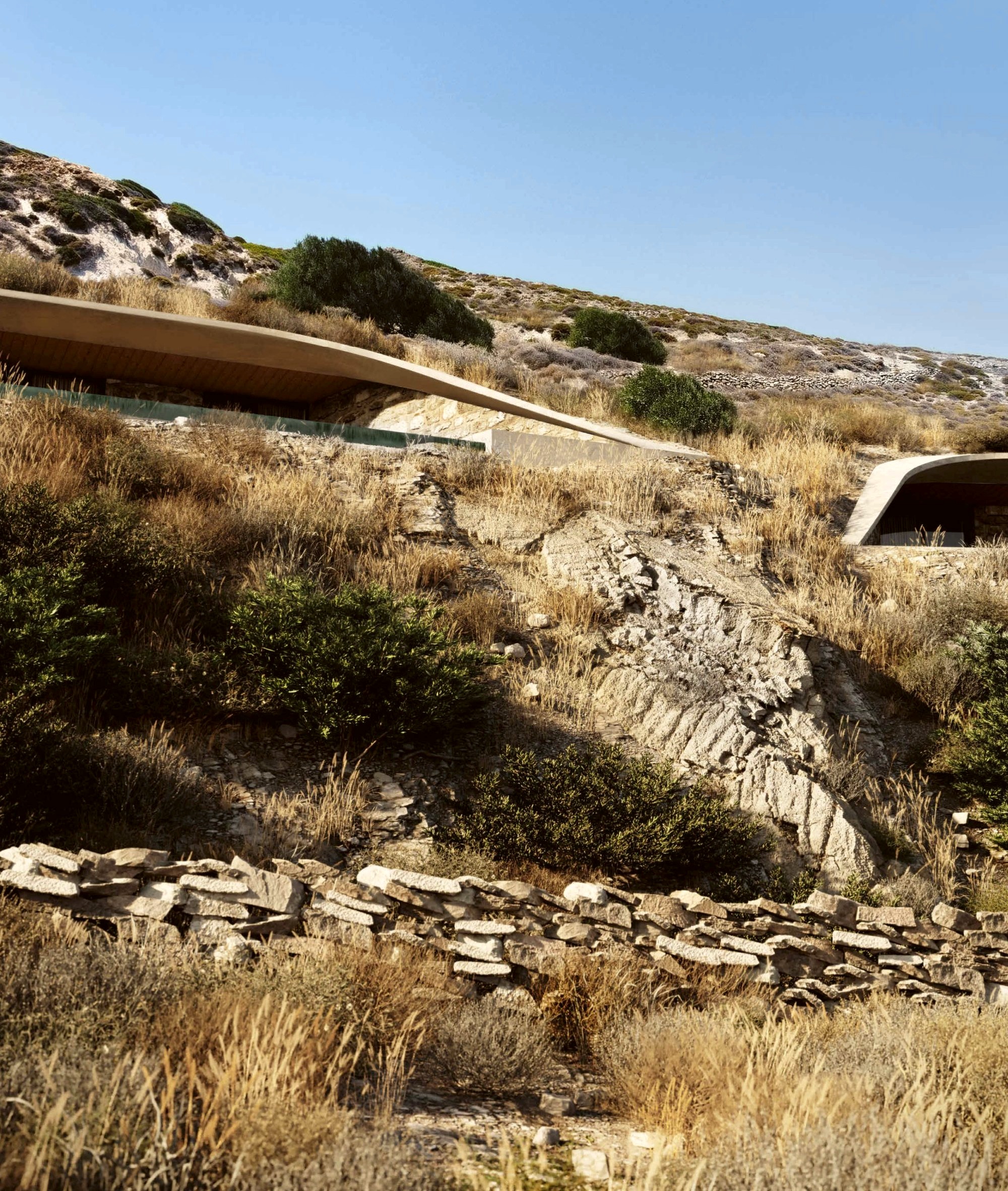 The villas' roofs following the hillside, almost hidden in the landscape
